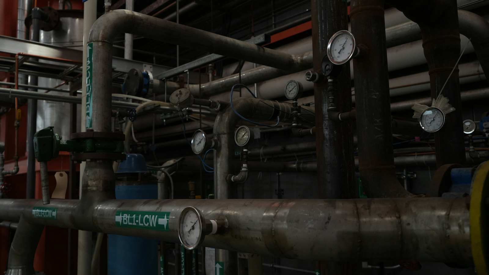 Plant room pipework fitted with pressure and temperature gauges.